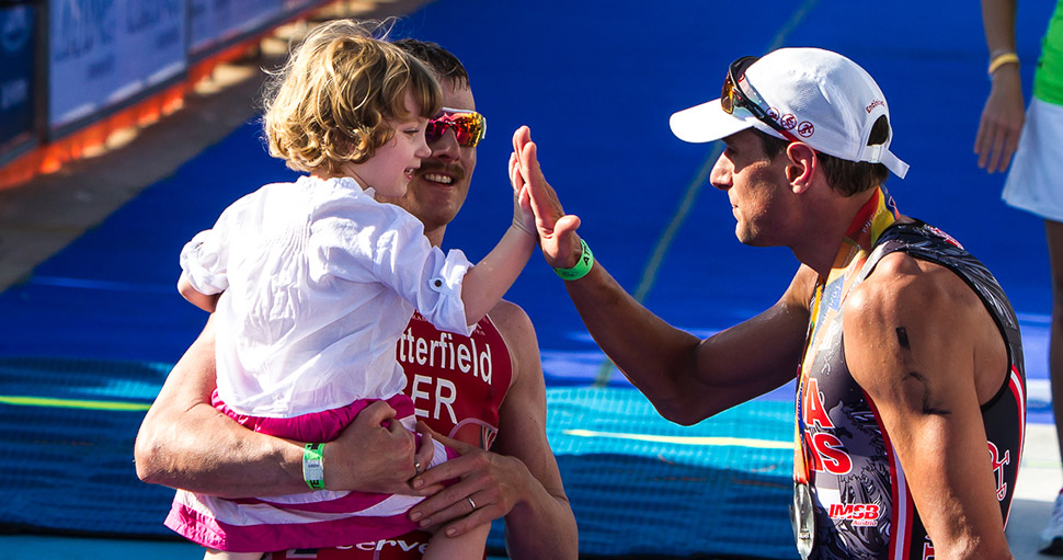 Photo courtesy of @TRIJUICE | Tyler Butterfield with daughter Savana after his 2nd place finish in Ironman Cozumel - congratulating winner Michael Weiss